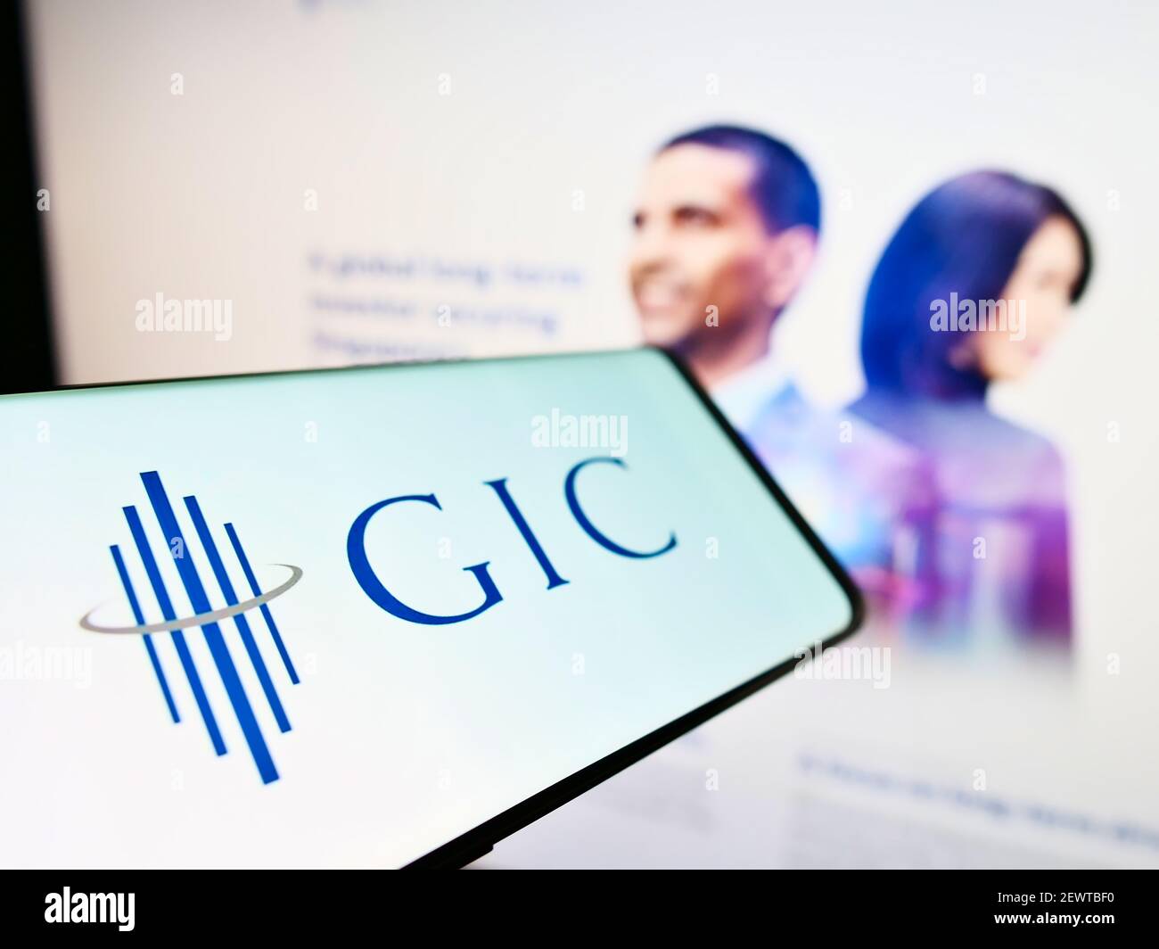 Cellphone with logo of Singaporean sovereign wealth fund GIC Private Limited on screen in front of web page. Focus on center-left of phone display. Stock Photo
