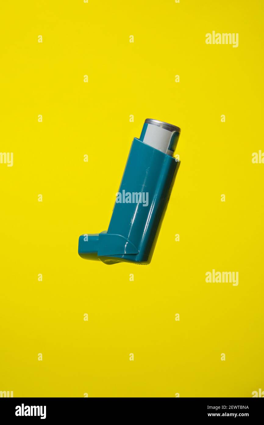 Vertical photograph of a salbutamol inhaler, an asthma medicine, on a ...