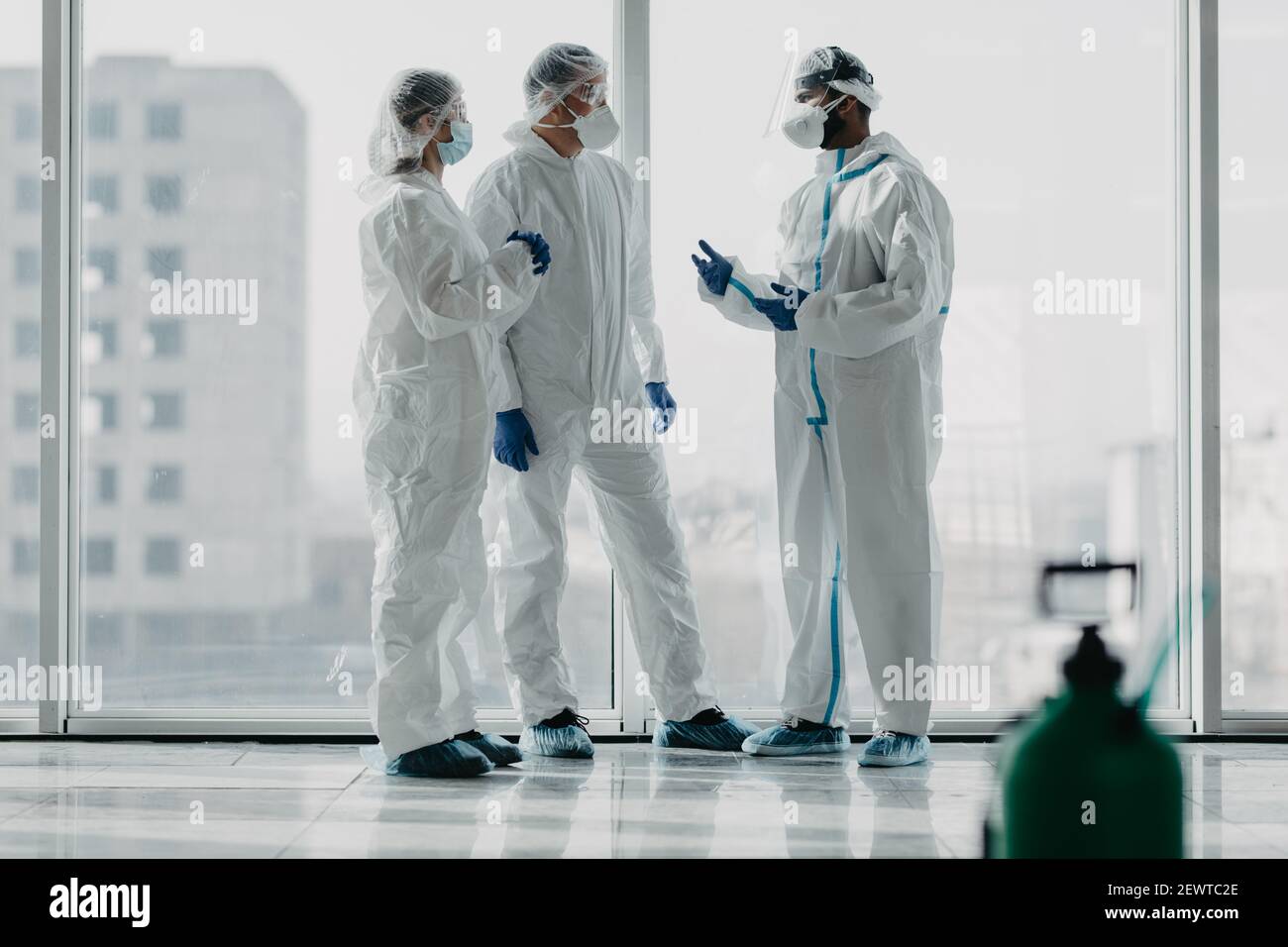 Team of doctors or nurses in hazmat gear have informal meeting about coronavirus in hospital, Covid pandemia Stock Photo