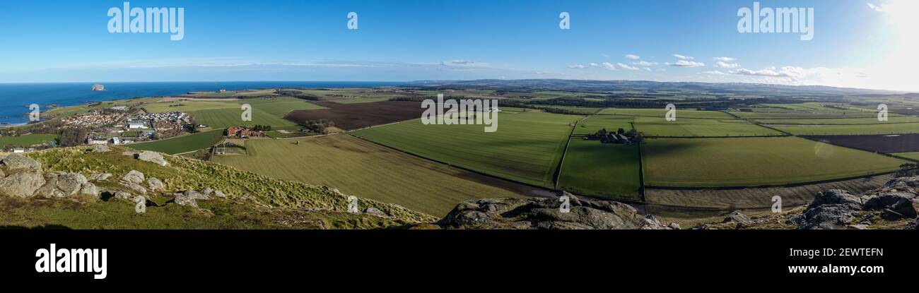 View, looking south from top of North Berwick Law, towards Bonnington Farm. Bass Rock in Firth of Forth in distance. Stock Photo