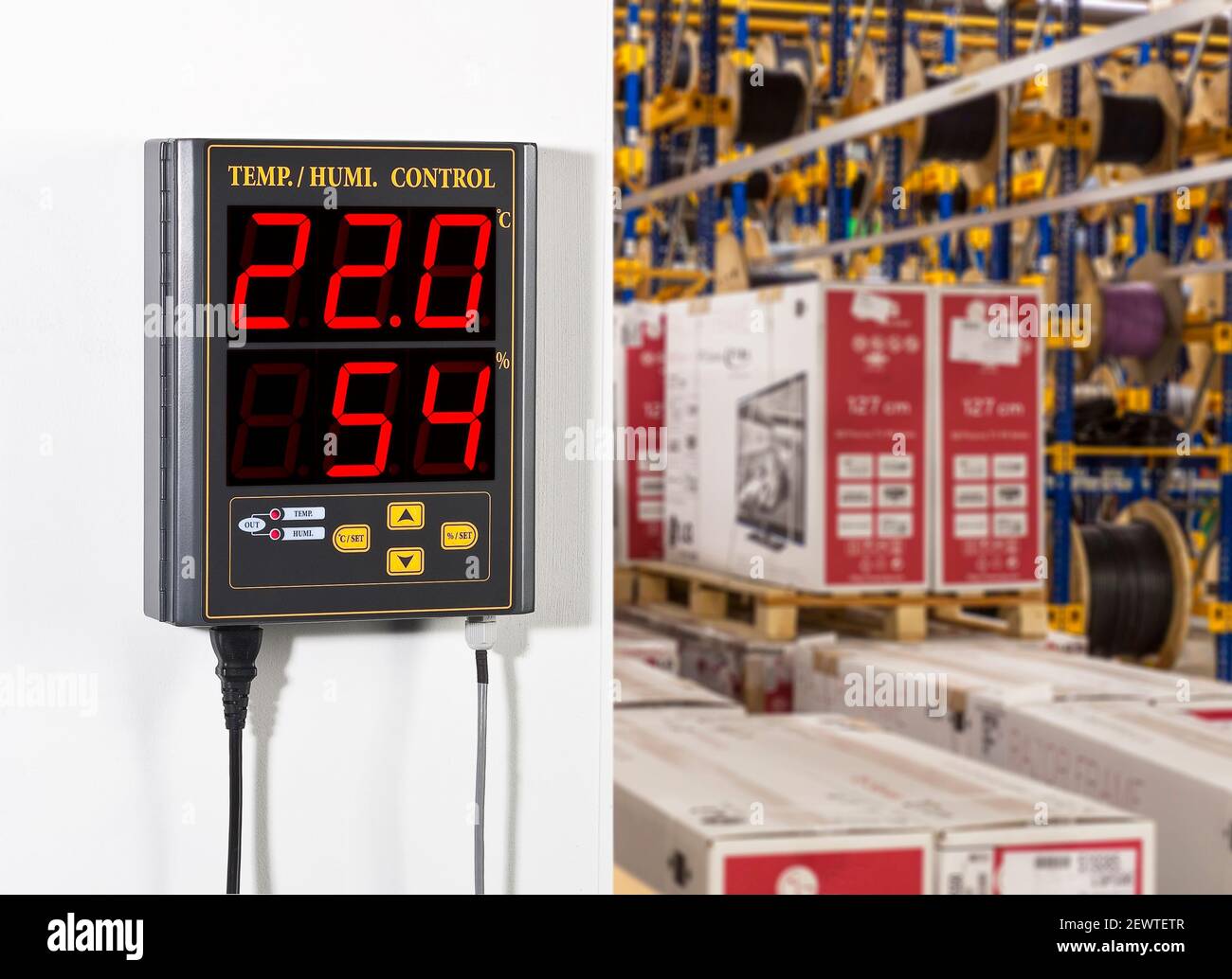 Thermo-Hygrometer wall mounted inside a business plant Stock Photo