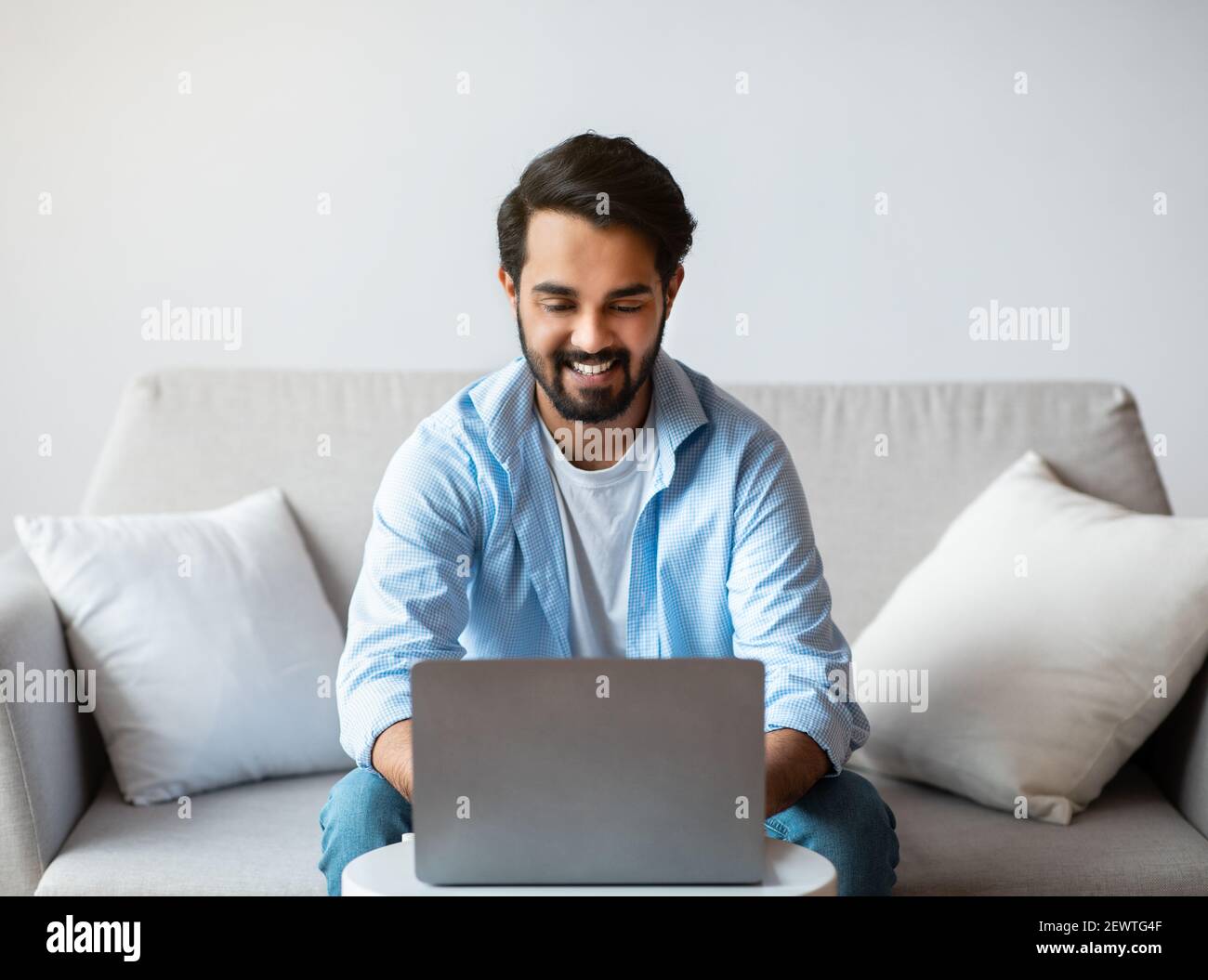 Telecommuting Concept. Cheerful Eastern Freelancer Guy Working Remotely ...