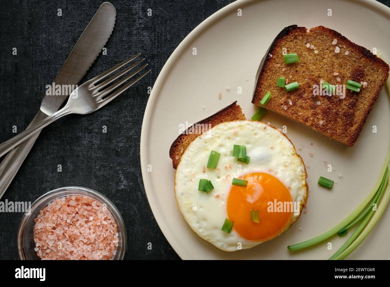 Fried egg and rye fried bread slices close up Stock Photo