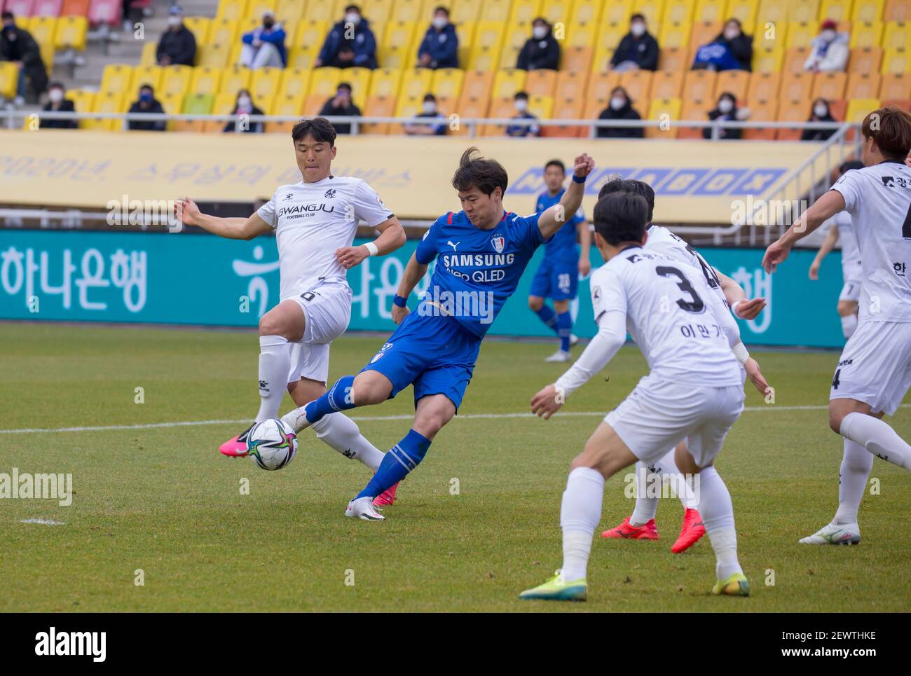 Suwon, South Korea. 28th Feb, 2021. Lee Chan-Dong (L) of Gwangju FC and Kim  Gun-Hee (2nd L) of Suwon Samsung Bluewings FC are seen in action during the  1st round of the