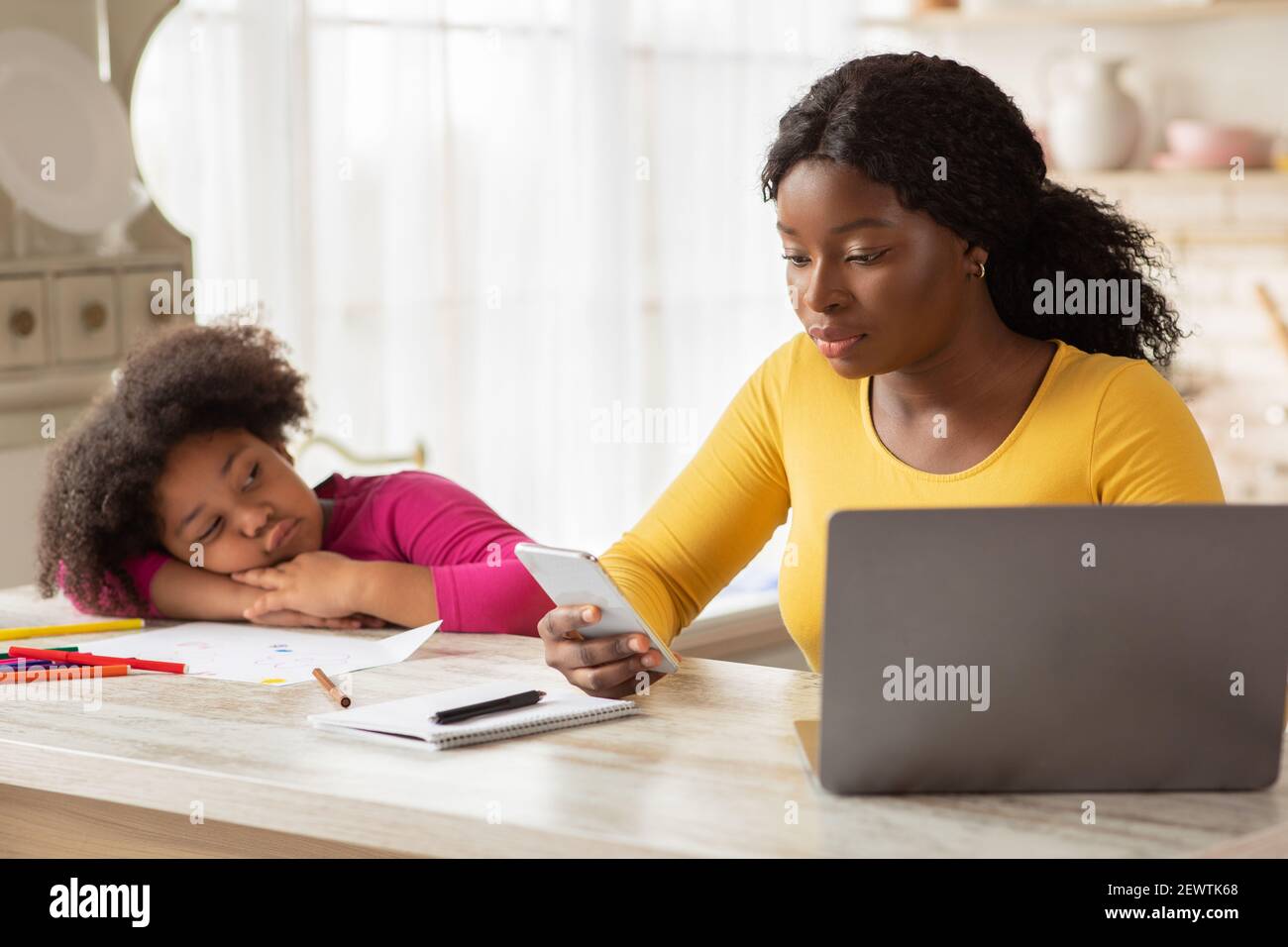 Busy Black Mother Working From Home, Ignoring Her Bored Little Daughter Stock Photo Alamy