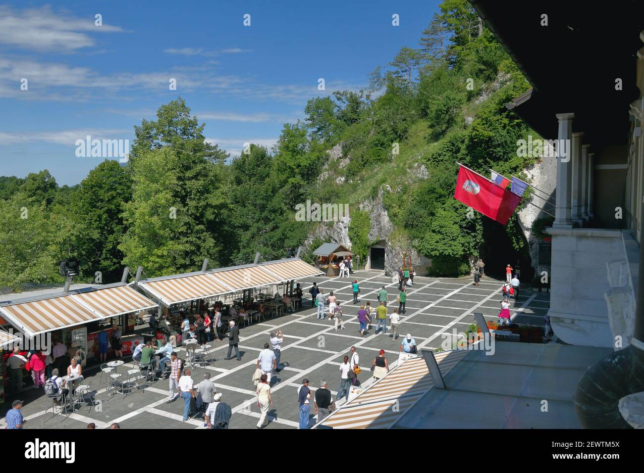 Postojna, Slovenia - Jun 26, 2011: Square with tourists in front of entrance to cave 'Postojnska jama' Stock Photo