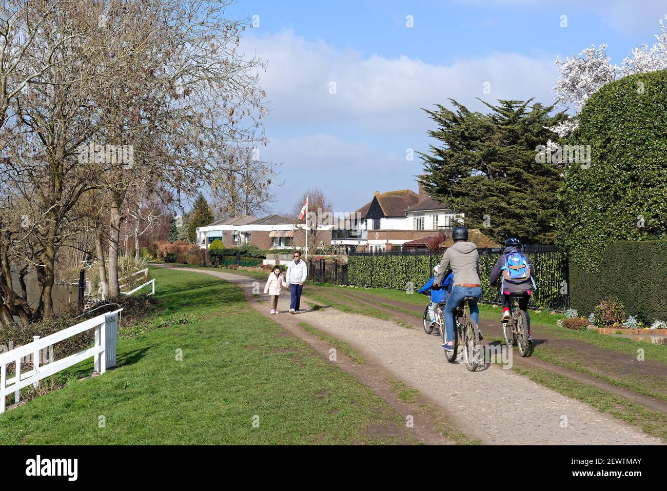 People walking on riverside footpath hires stock photography and