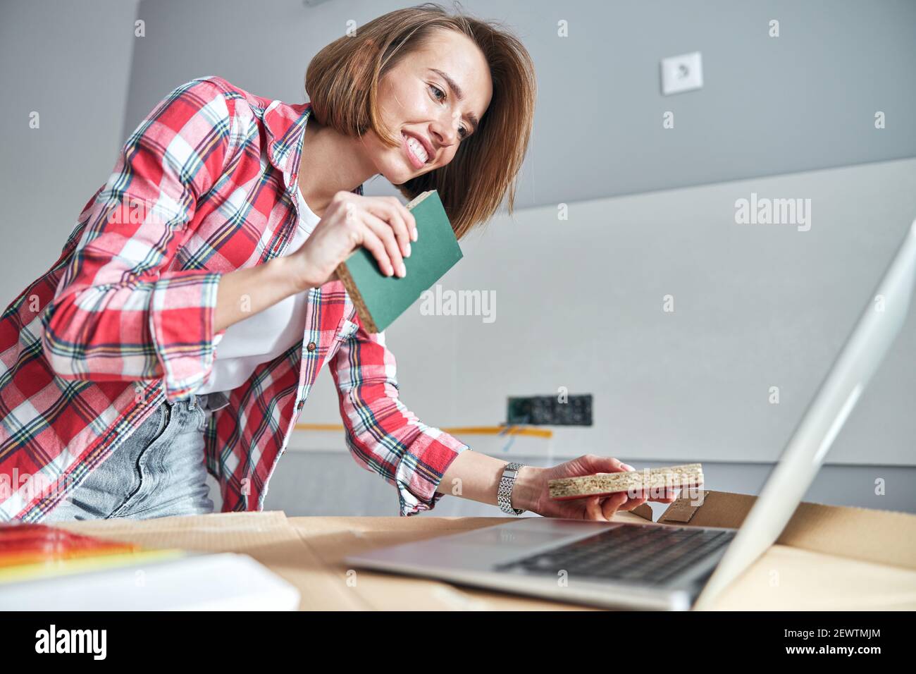 Interior designer demonstrating two paint samples on the mediumdensity