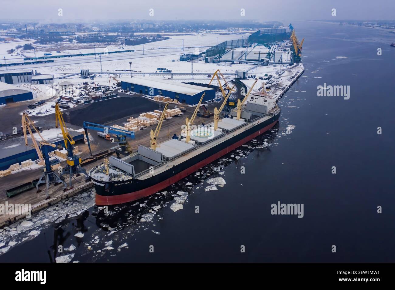 02-02-2021 Riga, Latvia. Logistics and transportation of International Container Cargo ship with tugboat in the ocean, Freight Transportation, Shippin Stock Photo