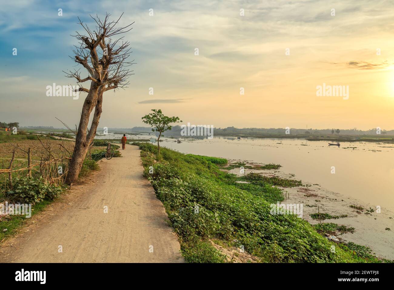 Rural India Landscape With Unpaved Village Road And River Bank At