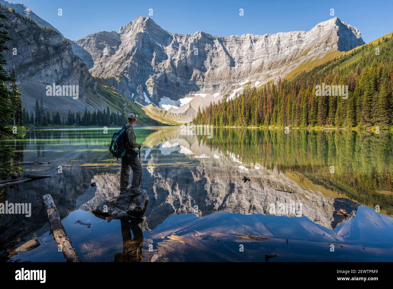 Senior hiker looking at view at Rawson Lake during summer in Kananaskis Country, Alberta, Canada. Stock Photo