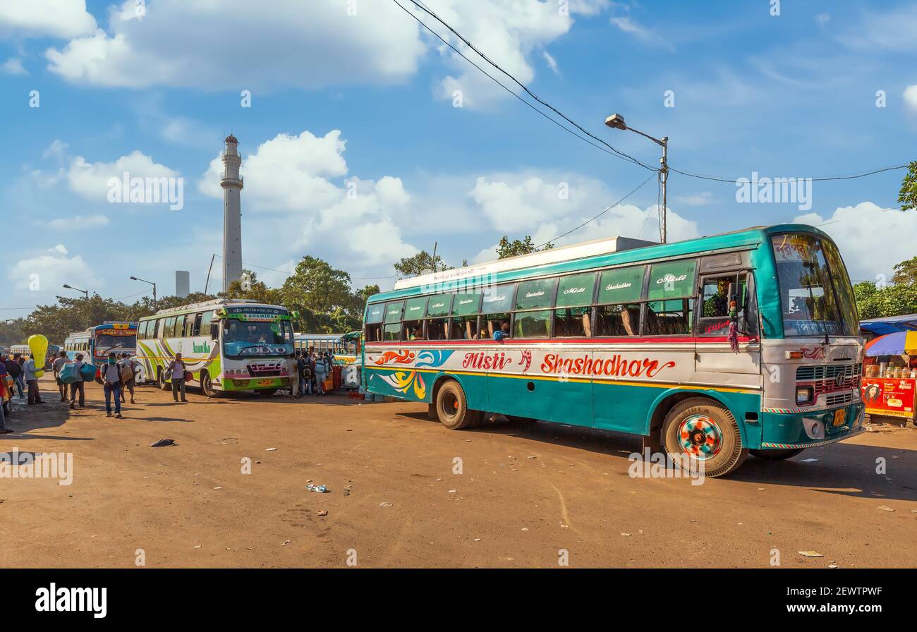 Public transport busses at city bus terminal near historic Shaheed Minar monument at Kolkata India Stock Photo