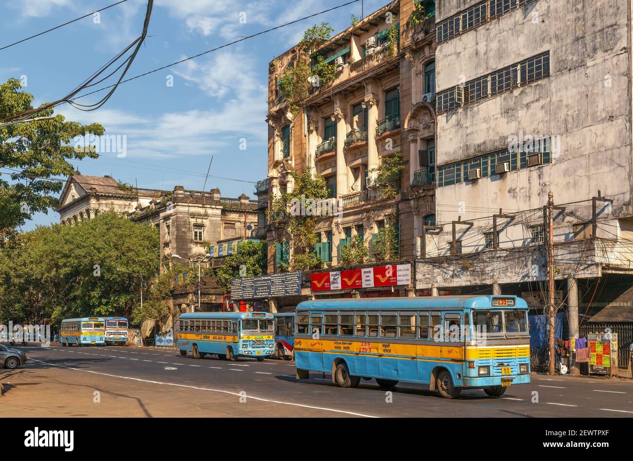 Public transport busses on city road in front of ancient heritage Government building at Dalhousie area of Kolkata Stock Photo