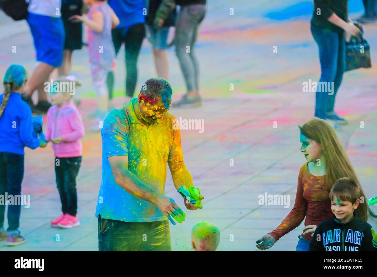 Russia, Moscow - June 25, 2017. A grown man with bright colors on his face. Laughs with happiness. Holi is a traditional holiday in India Stock Photo