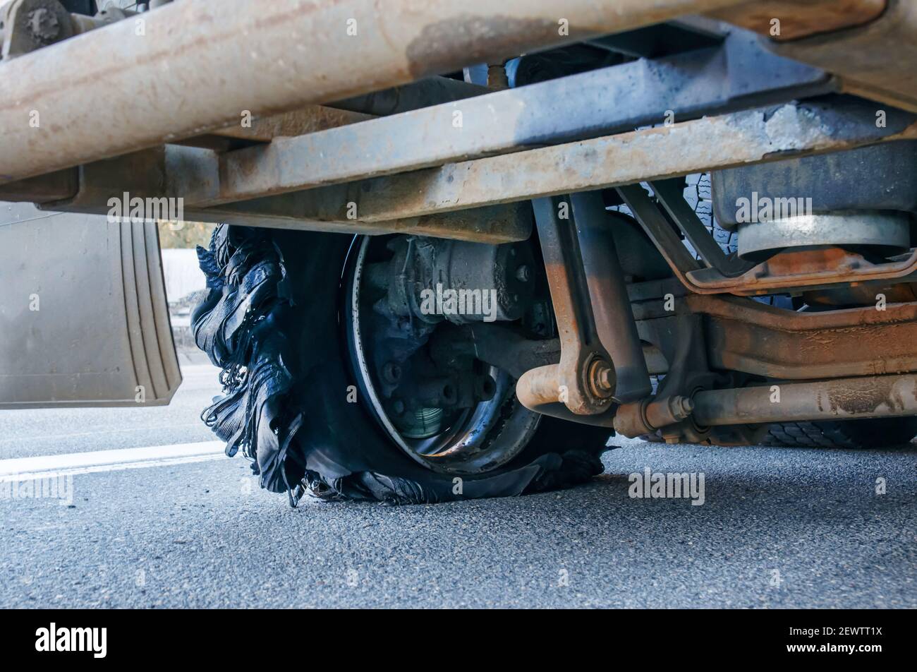 Close up of a truck with burst tyre on the motorway. Flat tire and Tire burst on the road Stock Photo