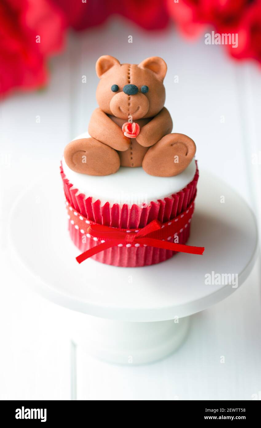 Valentine cupcake decorated with a fondant teddy bear Stock Photo