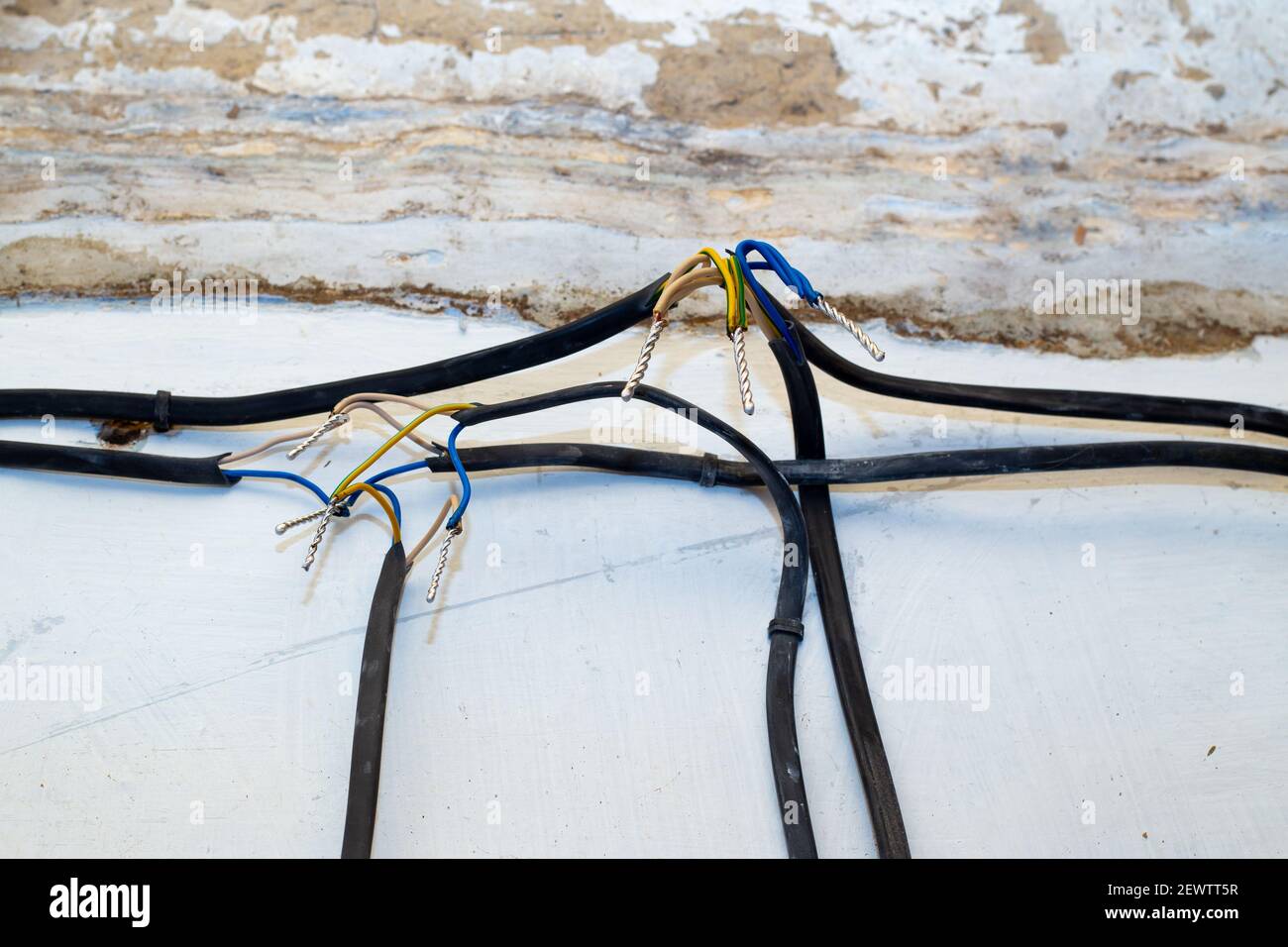Connection of wires against the background of a wall in a house under