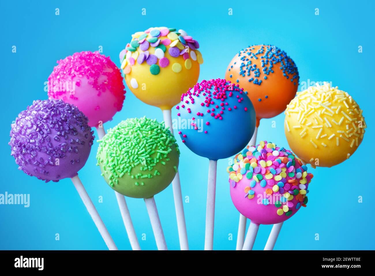 Brightly colored cake pops on a blue background Stock Photo