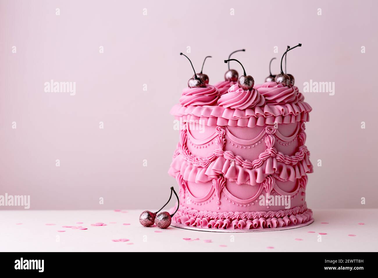 Ornate birthday cake with vintage style buttercream ruffles and cherries Stock Photo