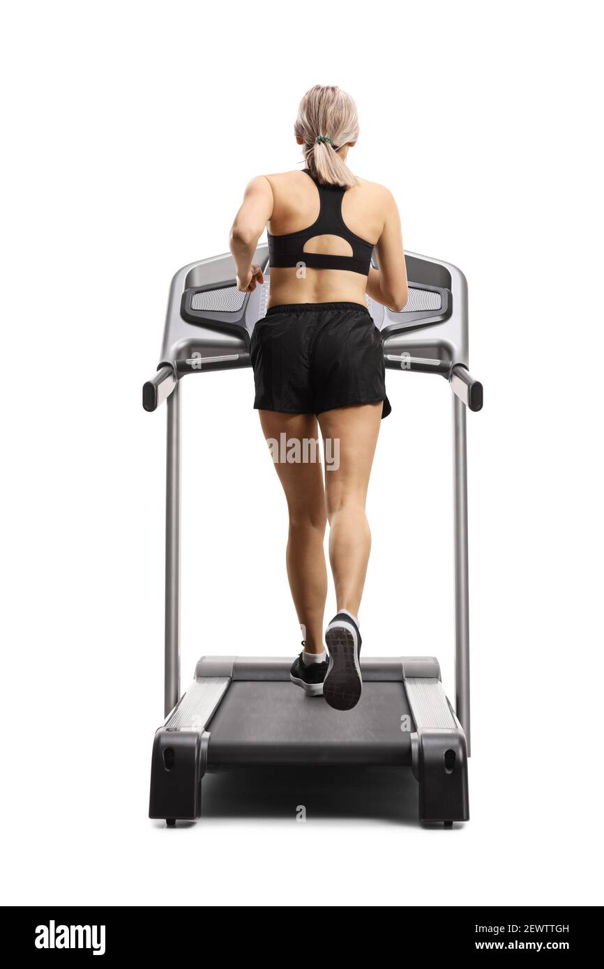 Rear shot of a woman in sport shorts running on a treadmill isolated on white background Stock Photo