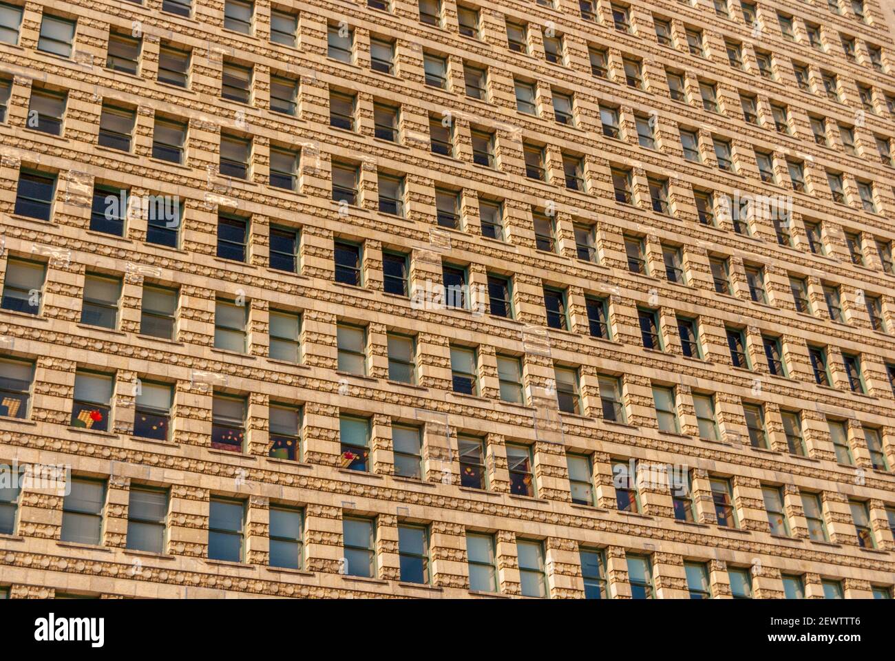 Looking up at a wall of windows on the building at 122 Michigan Ave