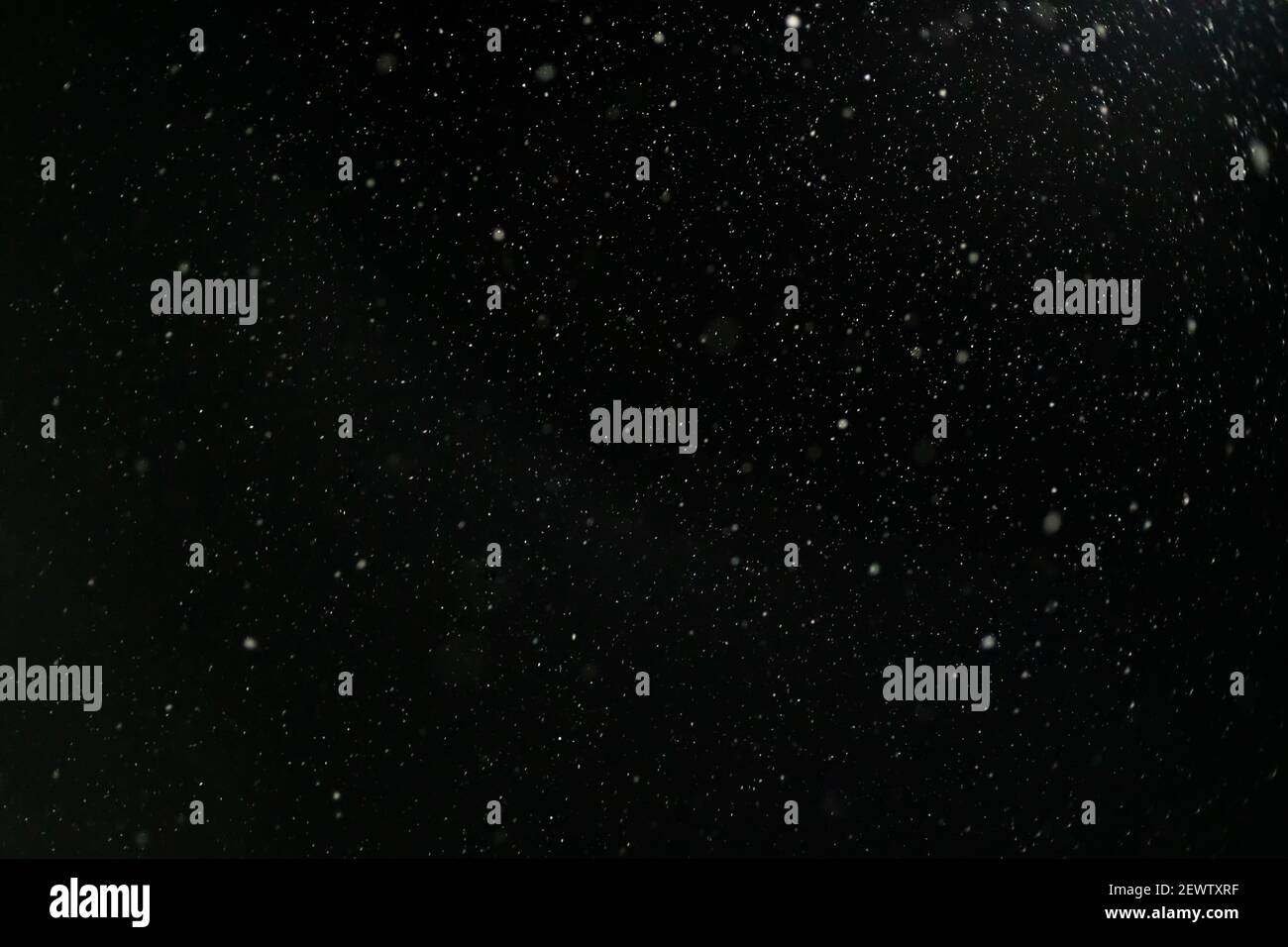 Snow against a black sky. Snow on a black background. Snow background. Stock Photo