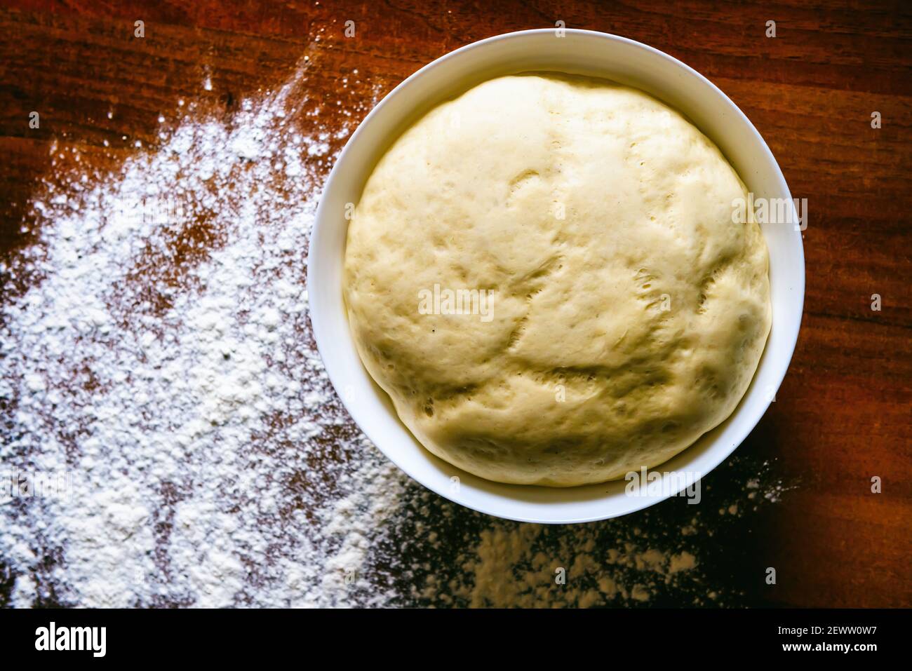 Preparing dough for white bread, rolls, pizza. Yeast dough in a bowl