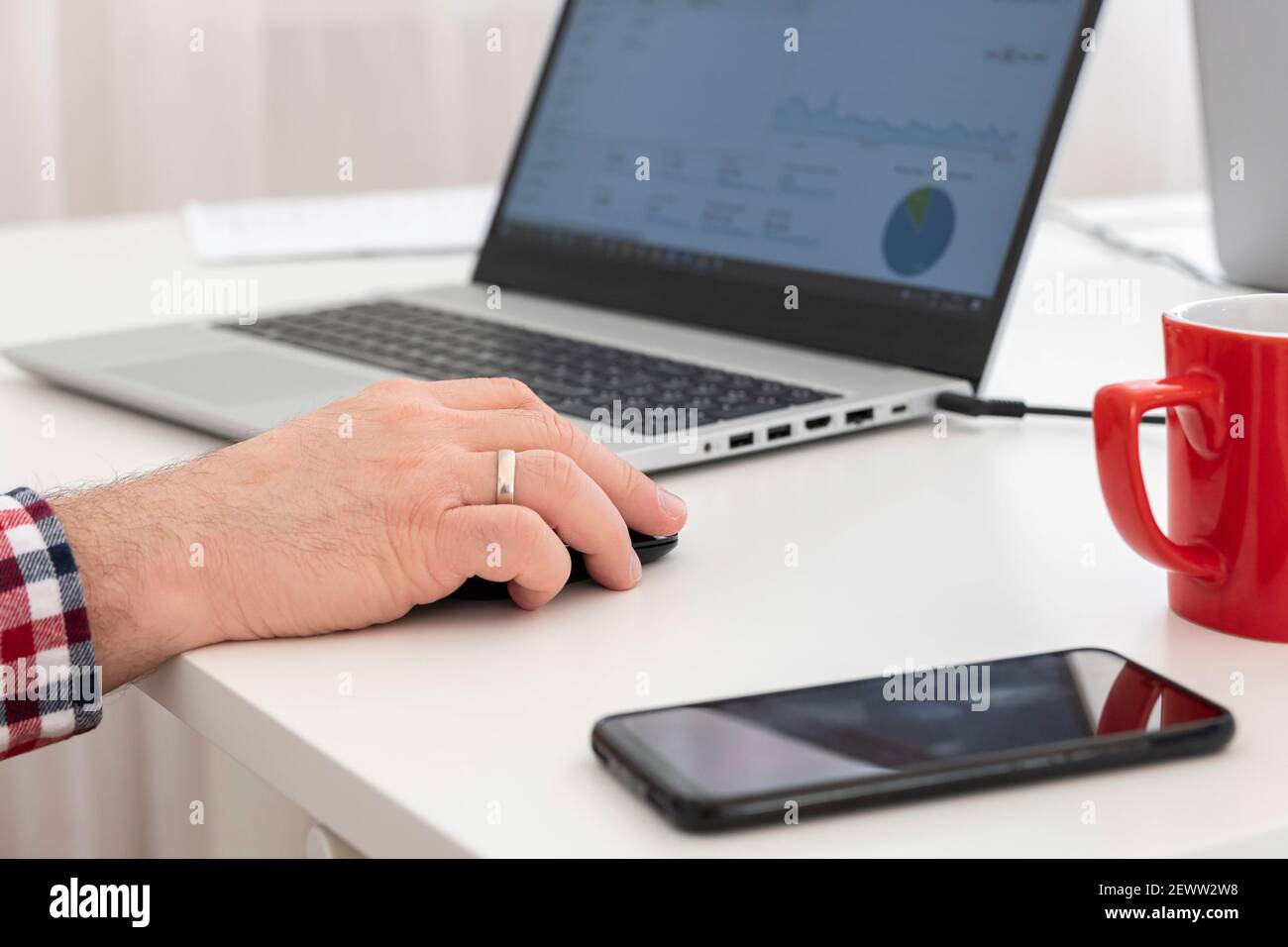 Closeup of business man's hand using computer mouse. Selective focus. Stock Photo
