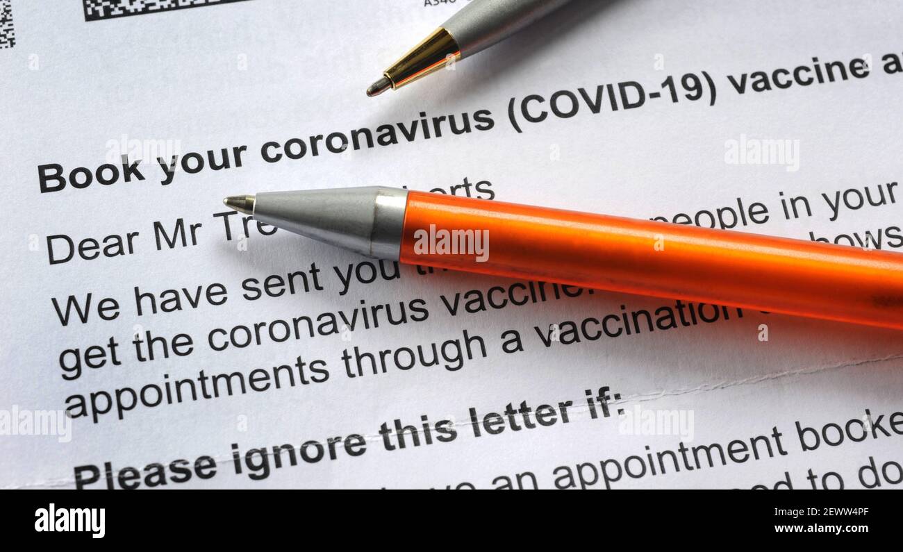 NHS CORONAVIRUS VACCINE BOOKING APPOINTMENT LETTER WITH PENS RE COVID-19 VACCINATION VACCINATE INJECTION  PANDEMIC JAB ETC UK Stock Photo