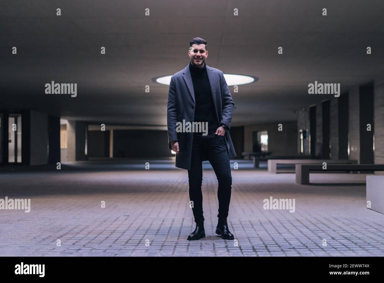 Handsome young businessman standing smiling. Stock Photo