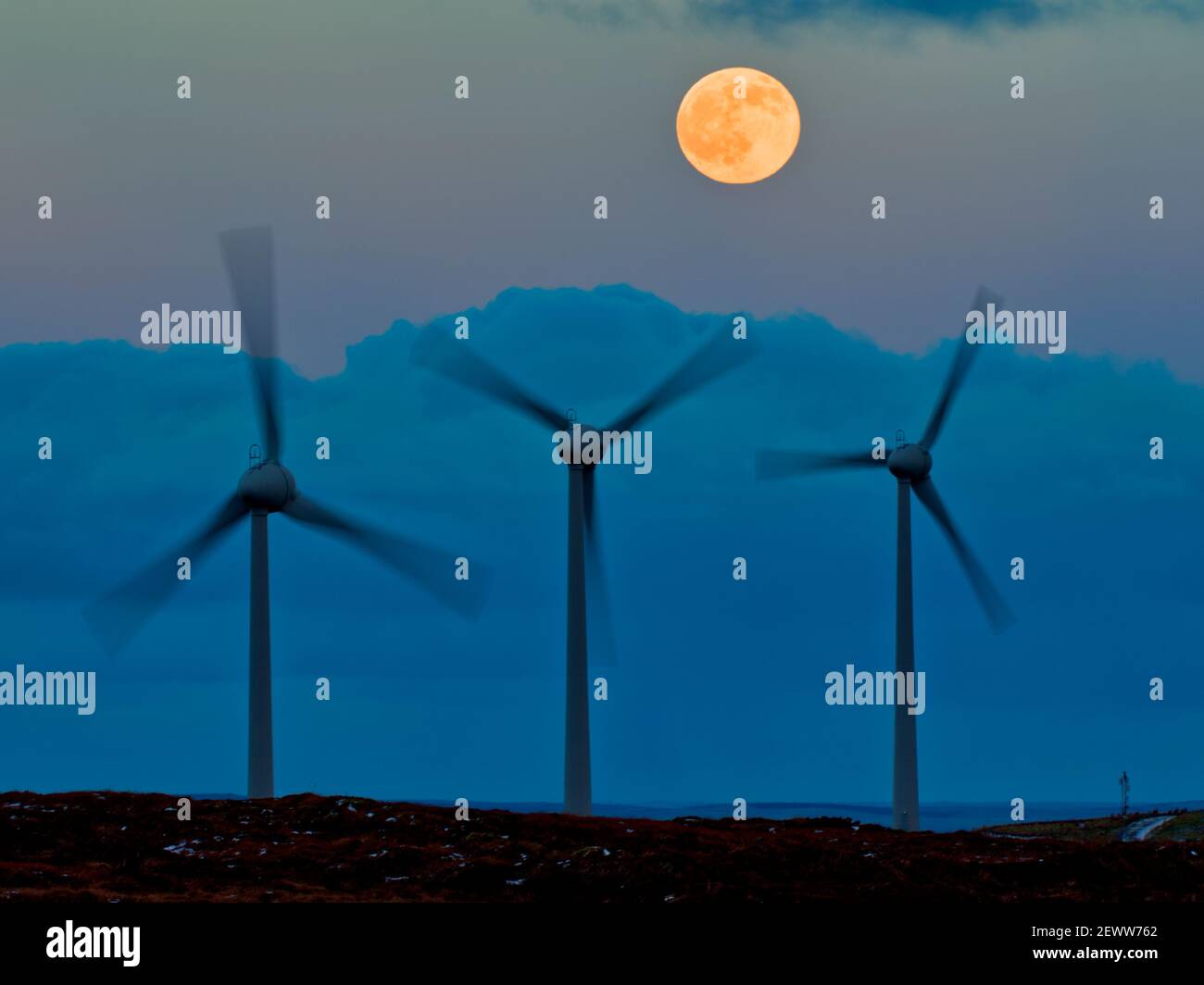 Wind turbines and full  moon, Orkney Isles Stock Photo