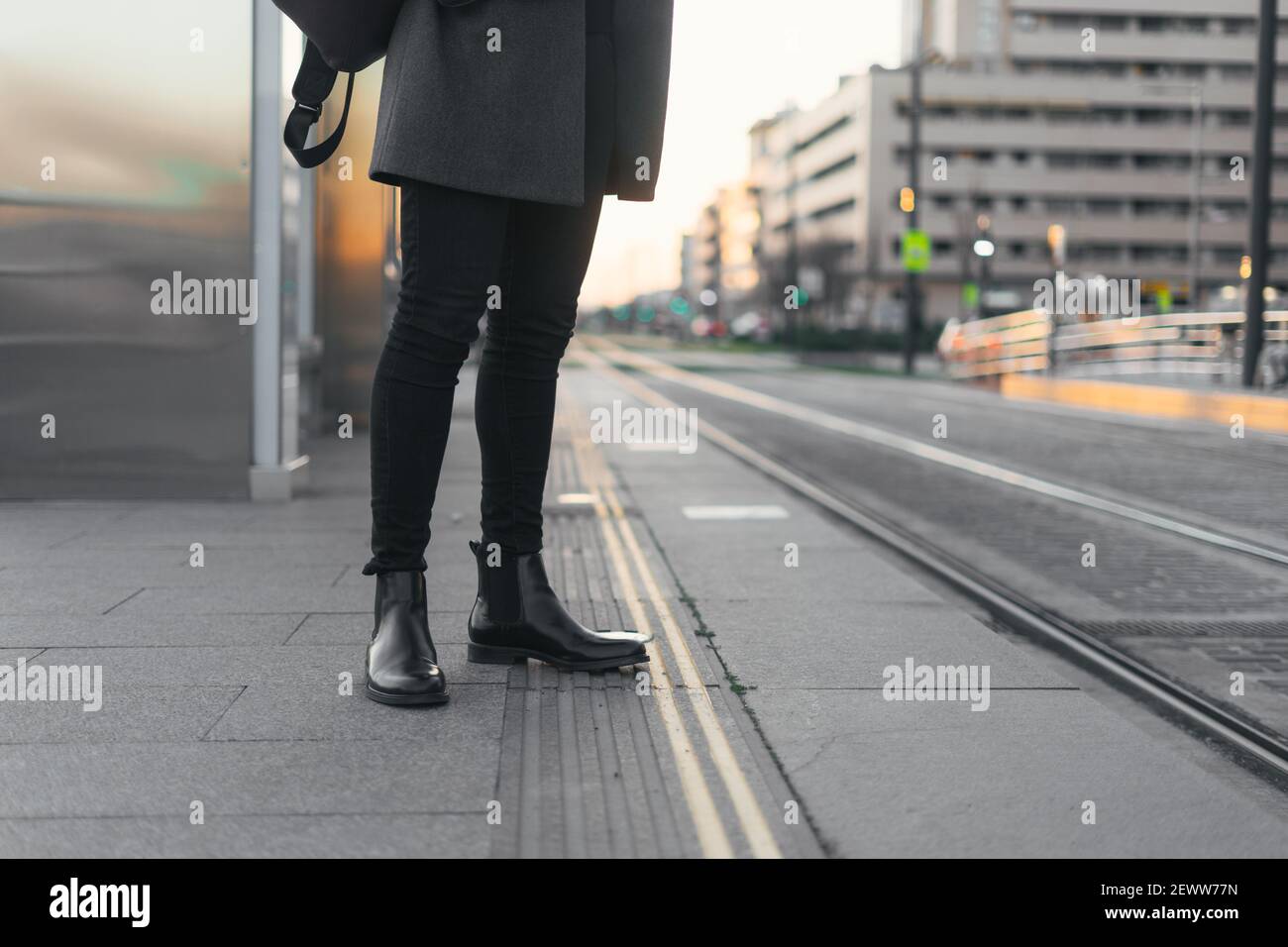Legs of a businessman in a mask waiting for the train at the station Stock Photo