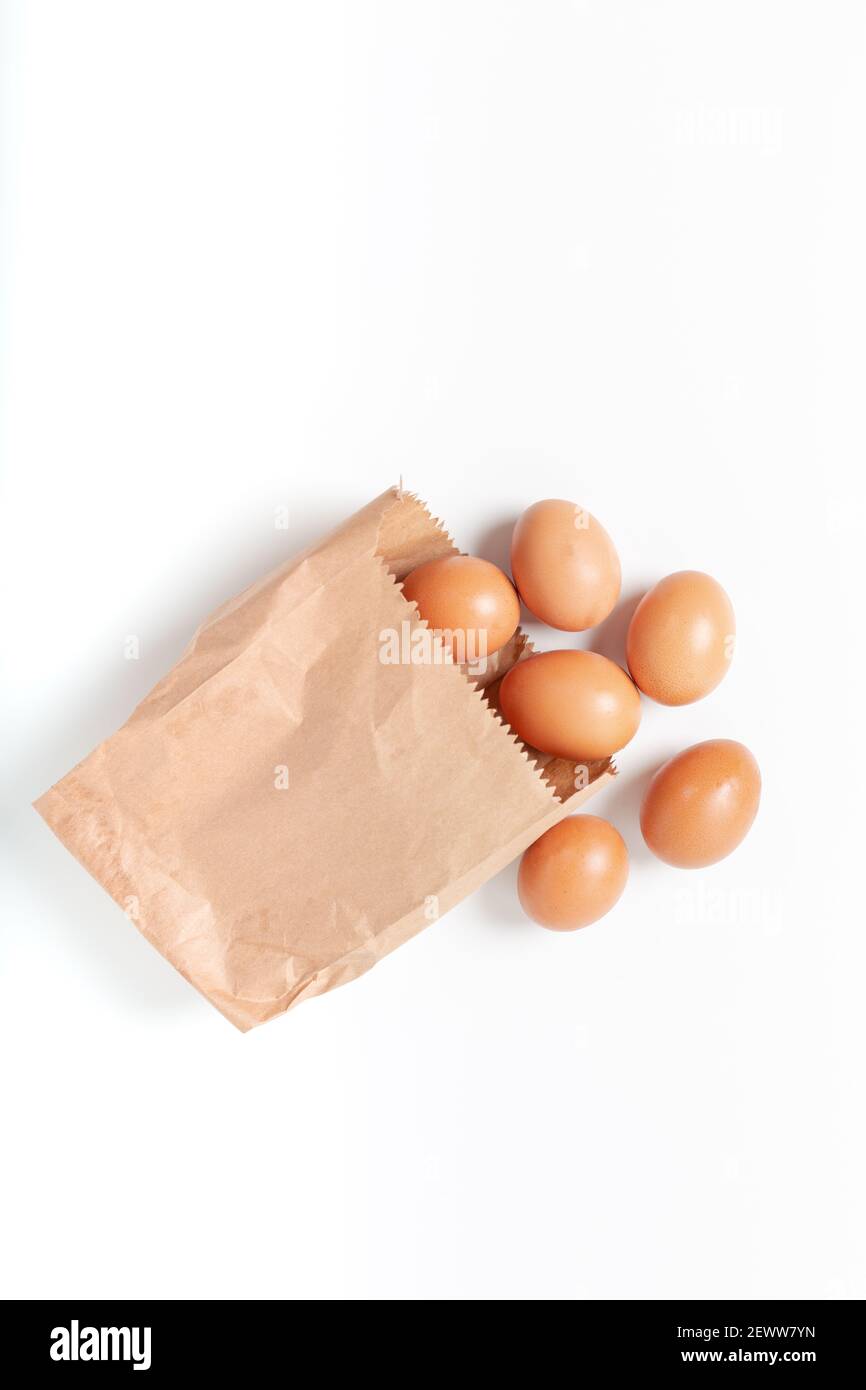 Brown eggs in paper pack on a white background. Stock Photo