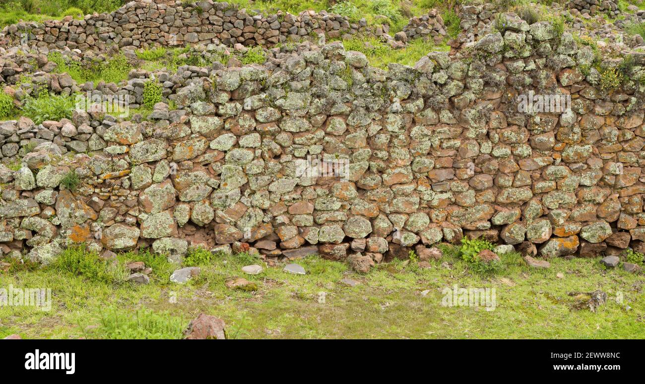 Pikillaqta archaeological site big stone wall in ruins in Cusco, Peru Stock Photo