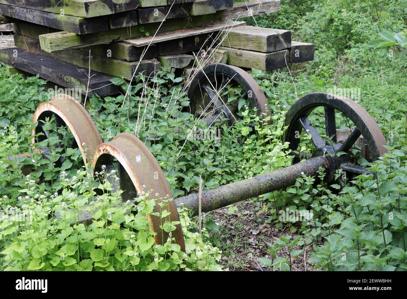 Heritage railway line outdoor store with two sets of rusty train wheels