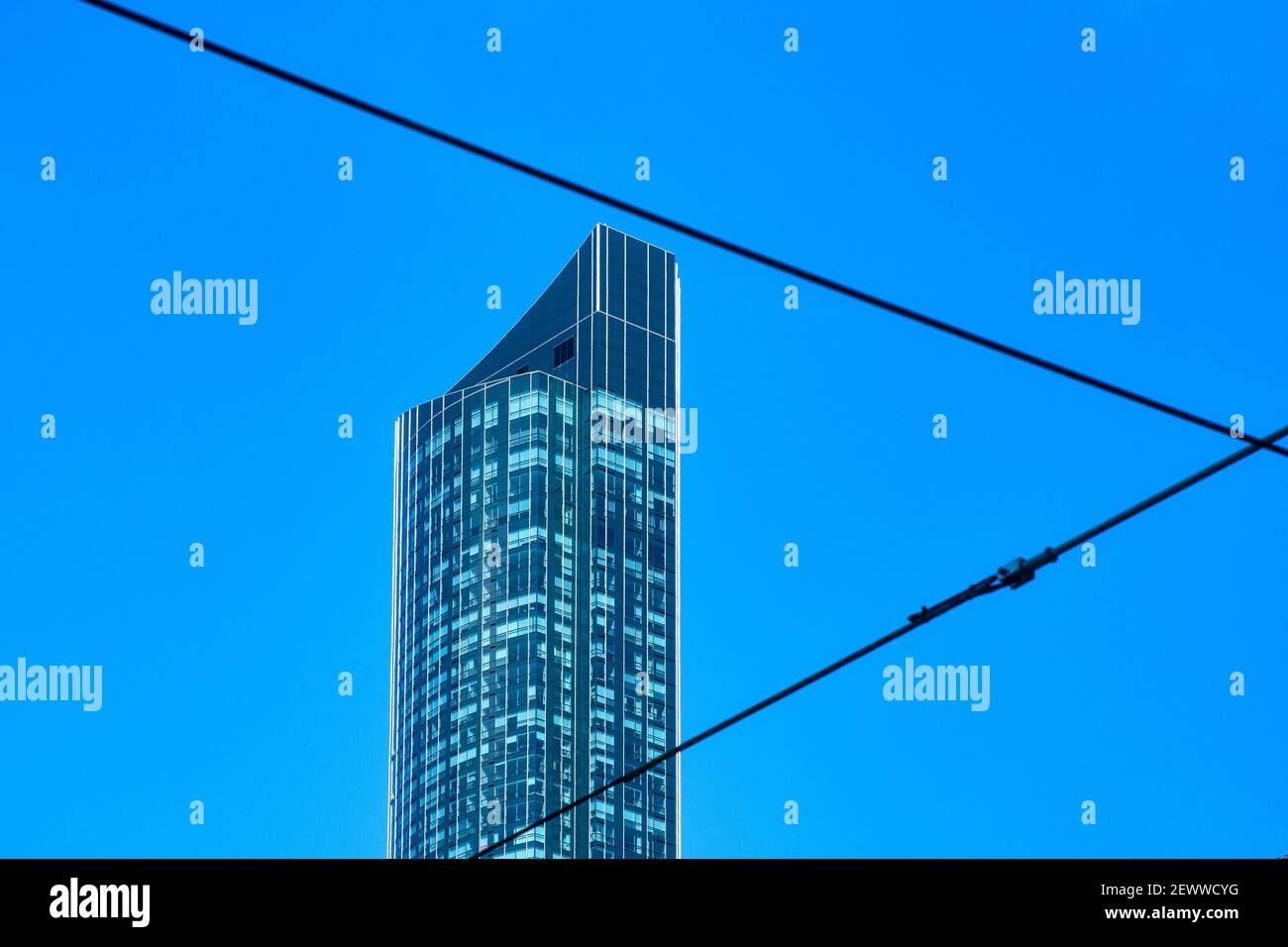 The Aura building framed between two electric wires, Toronto, Canada Stock Photo