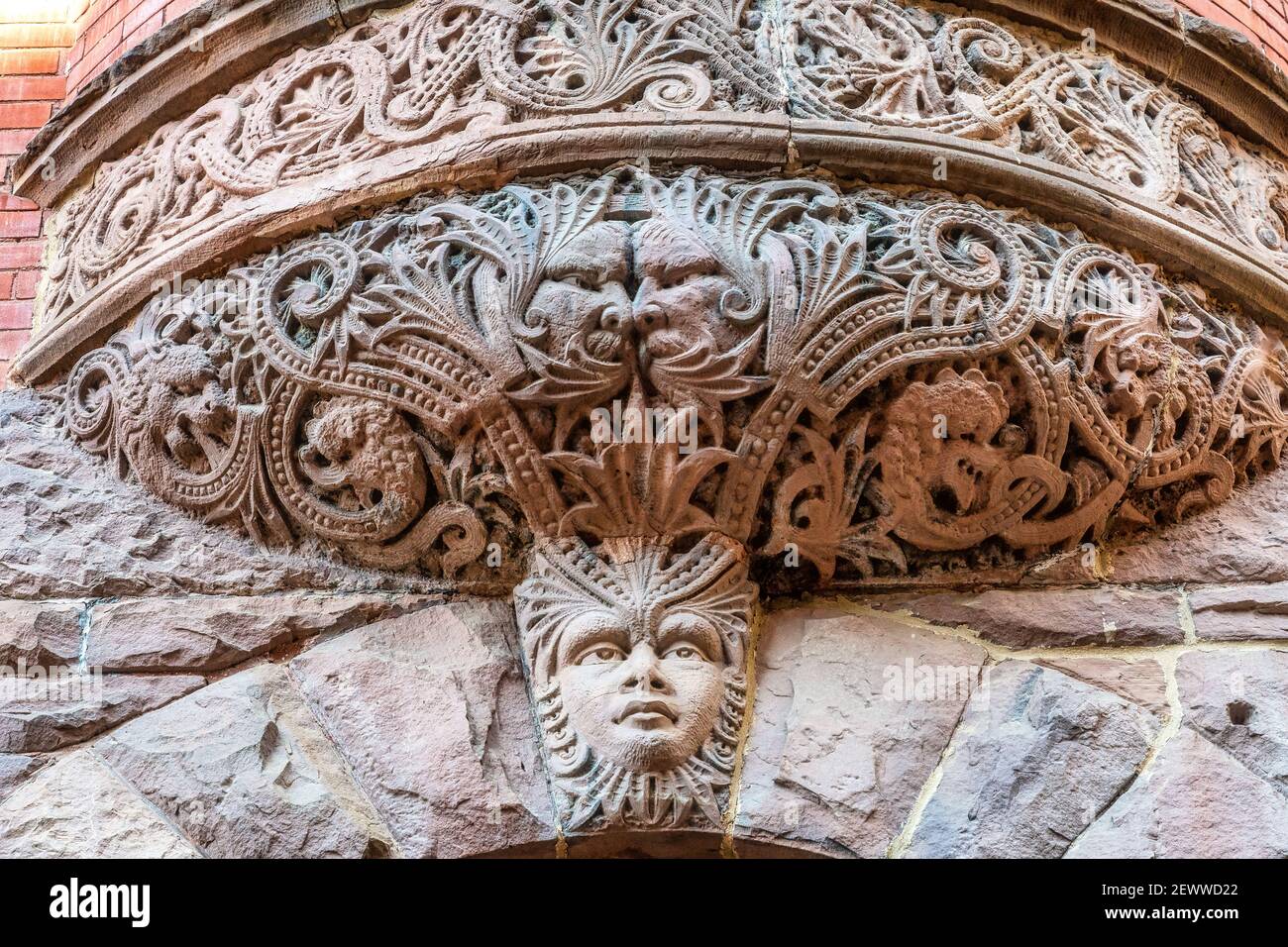 A balcony decorations on a pink sandstone building belonging to the University of Toronto, Canada Stock Photo