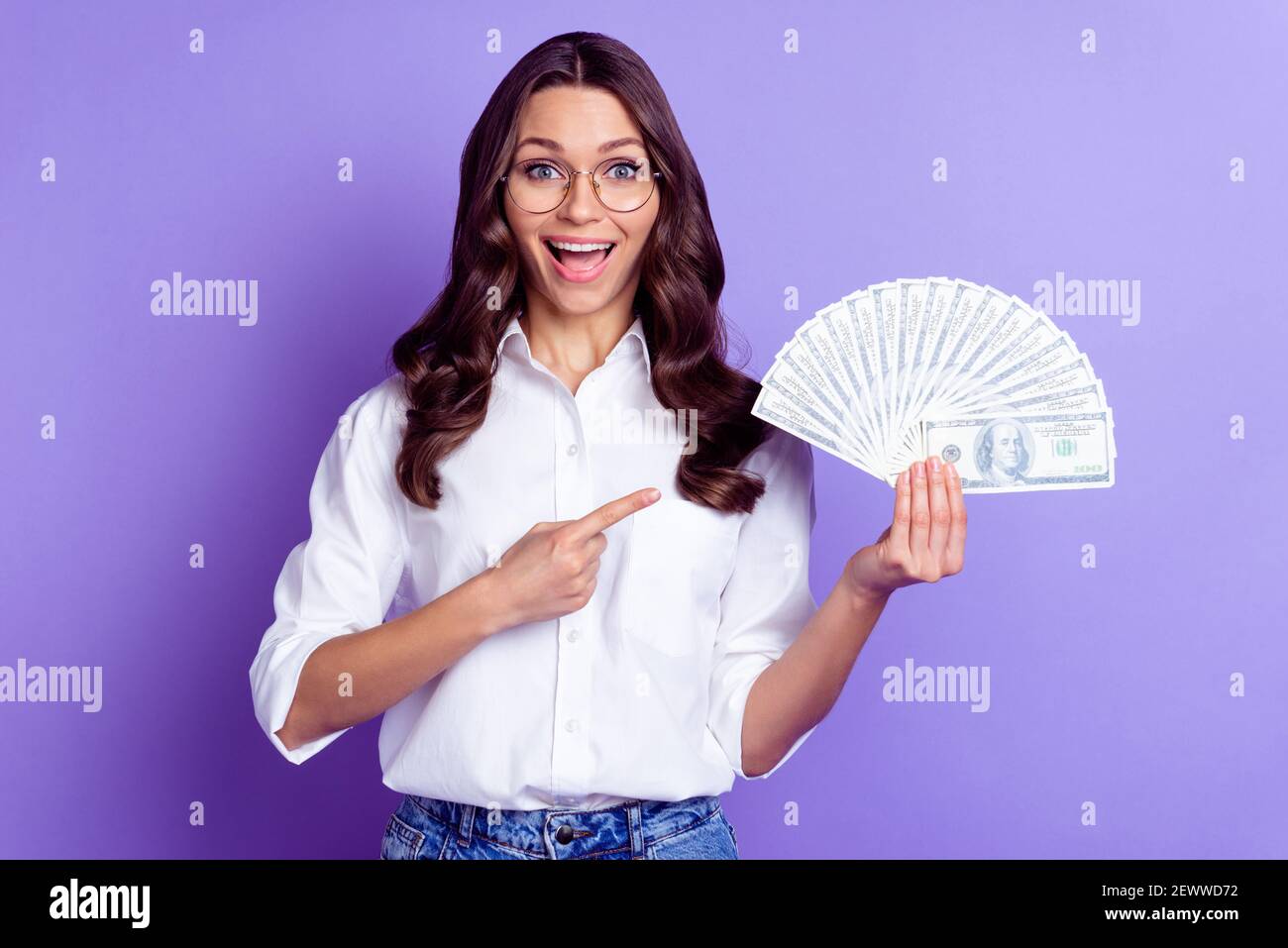 Photo of excited lady hold cash fan indicate finger wear specs white ...