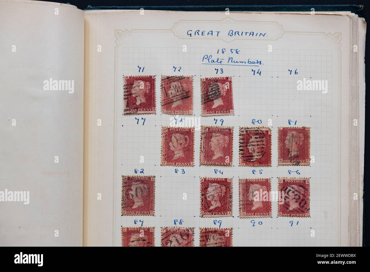 Penny Red stamps in old stamp album - UK Stock Photo