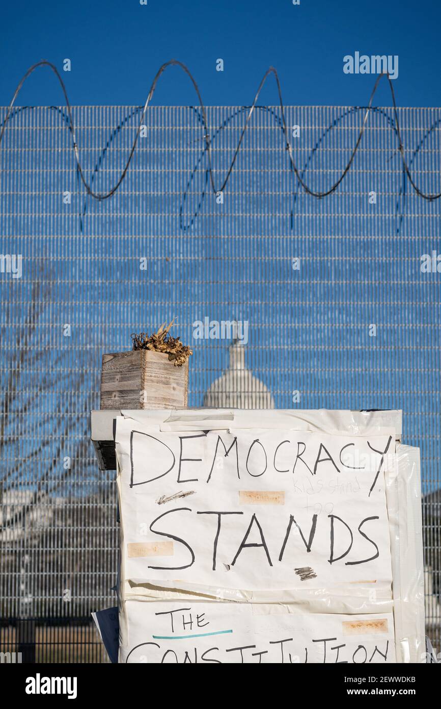 WASHINGTON D.C., UNITED STATES - Feb 25, 2021: Washington, D.C., USA- February 24th, 2020: A sign reading 'democracy stands' outside the fencing surro Stock Photo