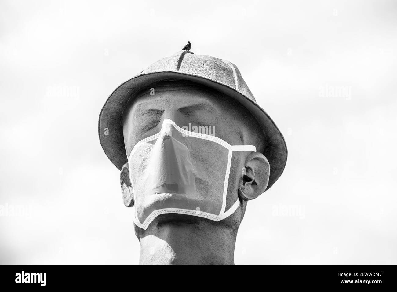 07 09 2020 Tulsa, USA Iconic Golden Driller - Huge statue of oilfield worker  near Route 66 in Oklahoma wearing facial mask during pandemic - Close-up Stock Photo