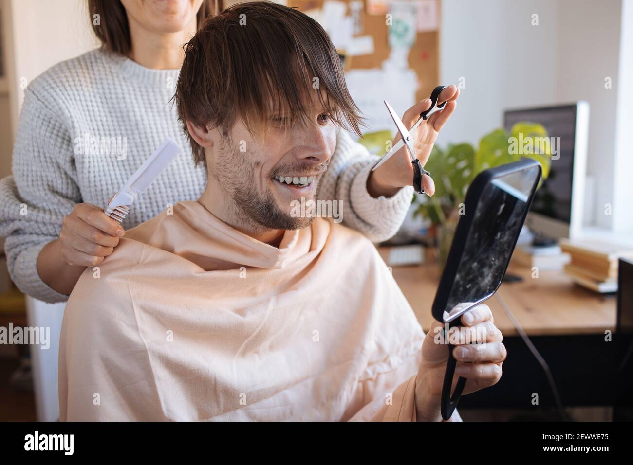 Home haircut. Man cutting hair at home. Life in pandemic during lockdown. How to cut your own Hair when hairdressers are closed. Easiest Self-haircut Stock Photo