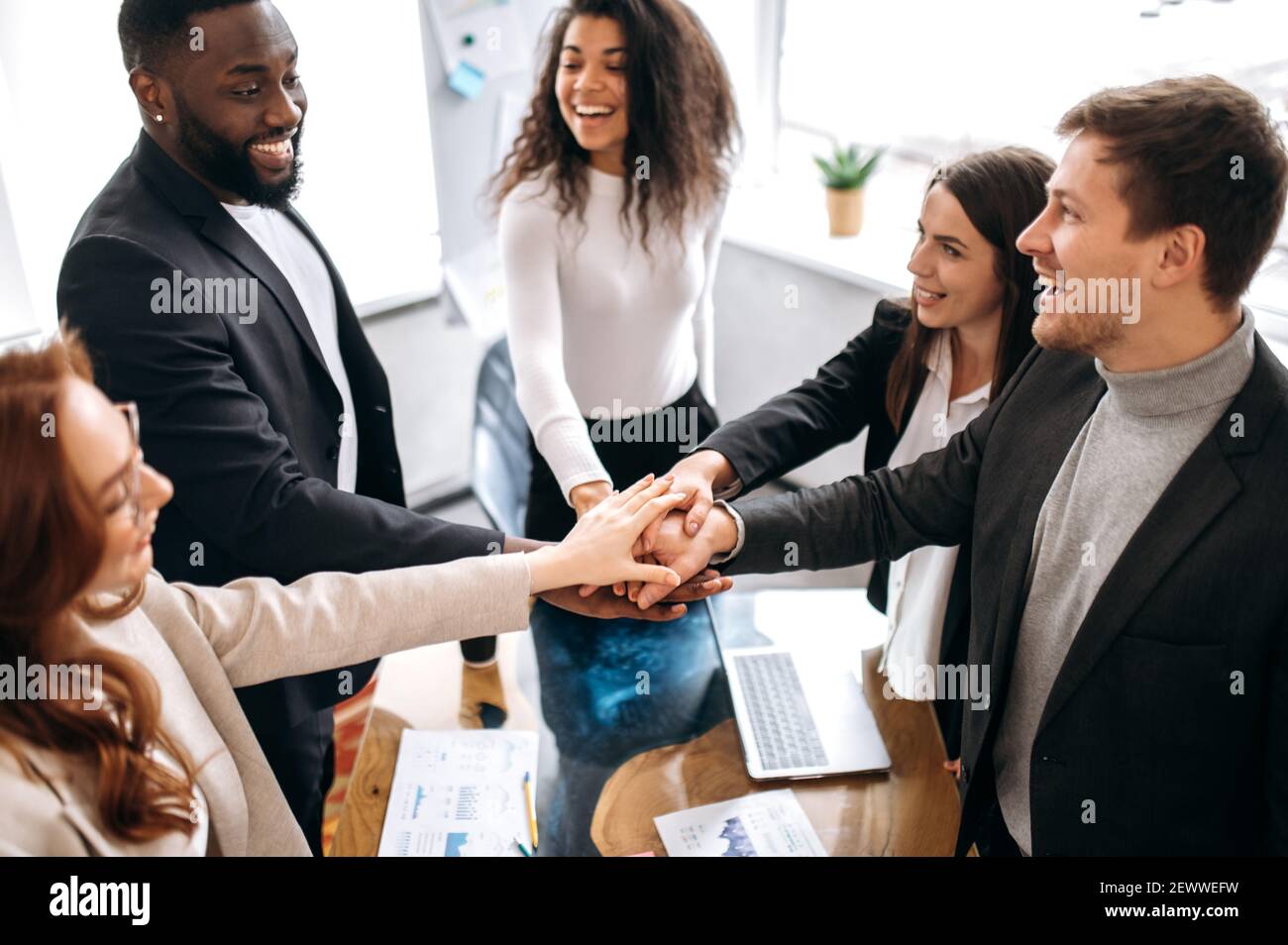 Great Teamwork Mixed Race Successful Business Team Puts Their Hands Together Over A Workplace In Their Modern Creative Office Enjoy Of A Good Job Unity And Teamwork Concept Stock Photo Alamy