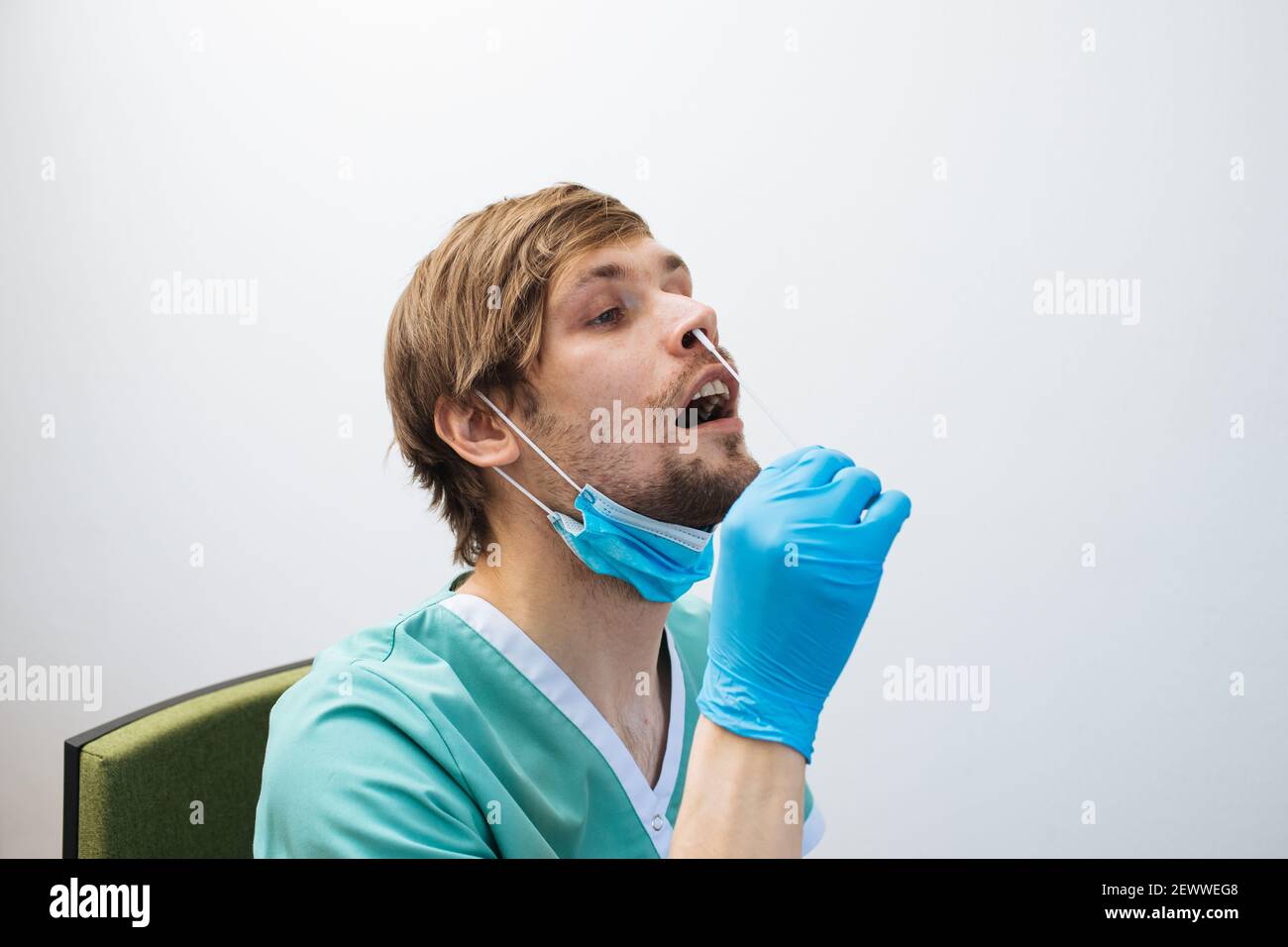 Man self test for COVID-19 home test kit. Male doctor Coronavirus nasal swab test for infection. Impact of COVID-19 on health care system and public Stock Photo