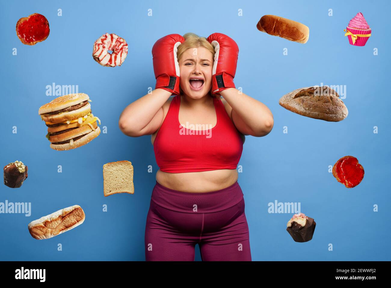 Fat girl is worried because she cannot lose weight and always think about eating. purple background Stock Photo