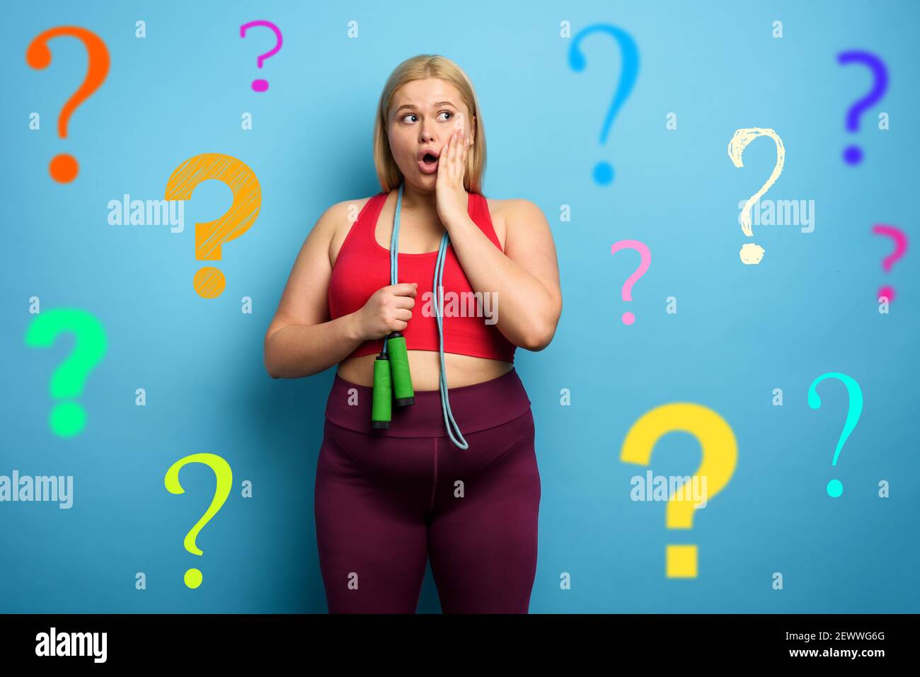 Fat girl does gym but is worried due to lot of questions. cyan background Stock Photo