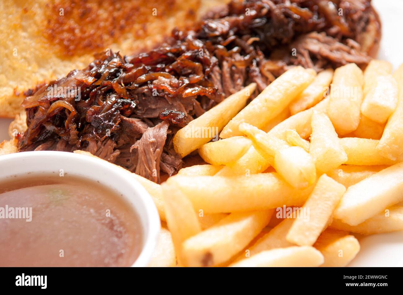 classic french dip au jus or beef dip with fries and sauteed onions take away Stock Photo Alamy