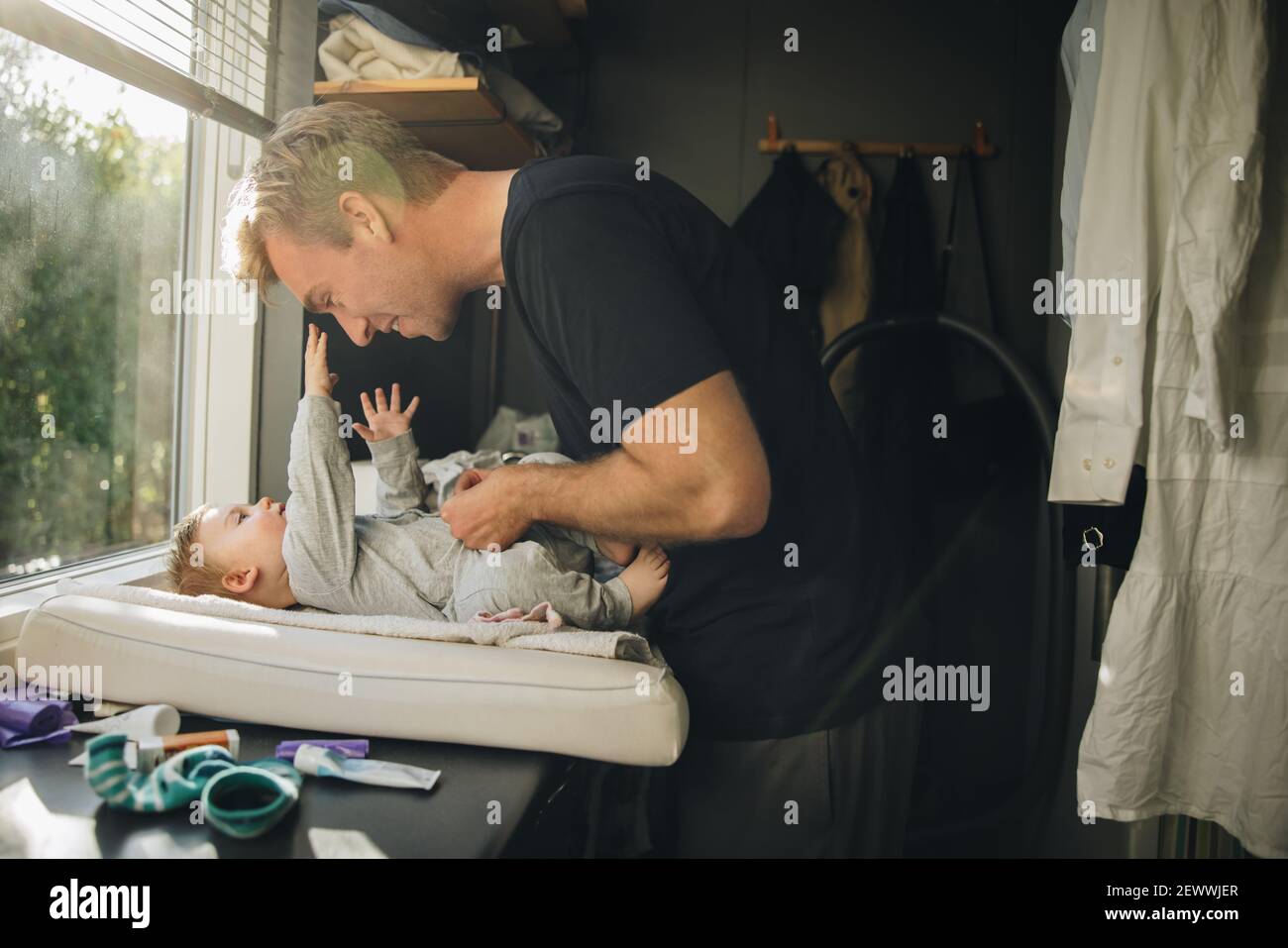 Man changing diaper of his baby. Caring father changing baby diaper at home Stock Photo Alamy
