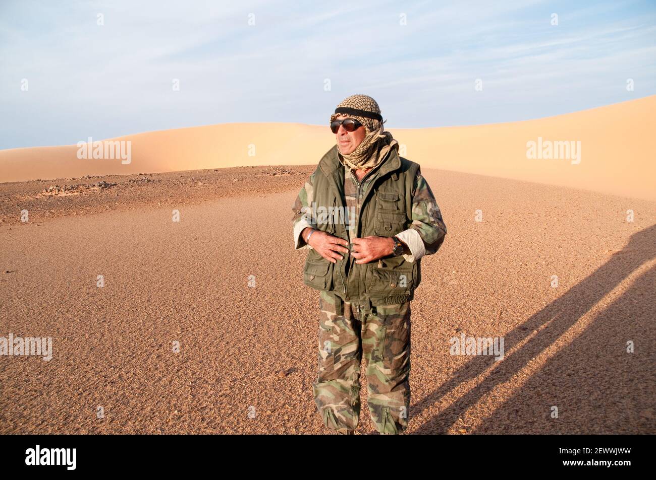 Egyptian desert explorer Ahmed Mestikawi standing beside a sand dune in the Great Sand Sea region of the Western Desert (Sahara) of Egypt. Stock Photo