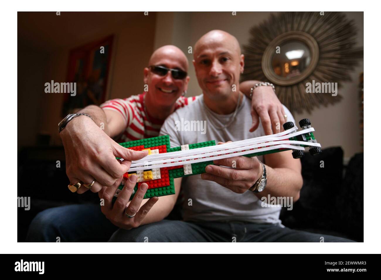 LEGO..... 'Right Said Fred' Fred (grey T shirt) and Richard (red stripe T shirt)  Fairbrass with their LEGO guitar at home in west London  pic David Sandison Stock Photo